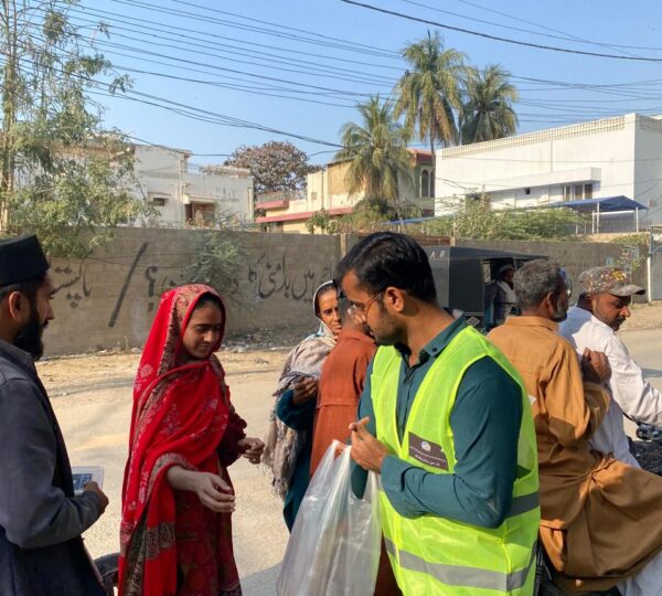 Volunteers giving out food packages to help needy individuals in their communities