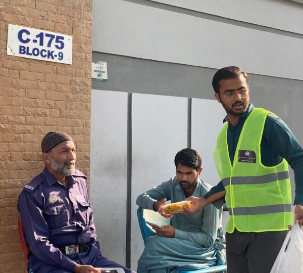 Volunteers distributing food and essential items to needy families as part of humanitarian outreach