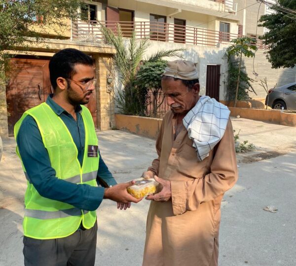 Food distribution drive showing volunteers assisting families with necessary provisions