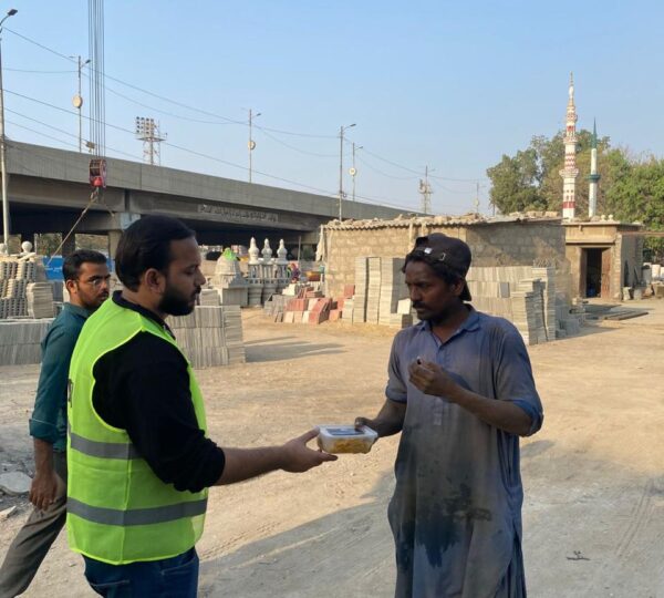 Volunteers handing out food items to needy families during a Skill Development Foundation community drive
