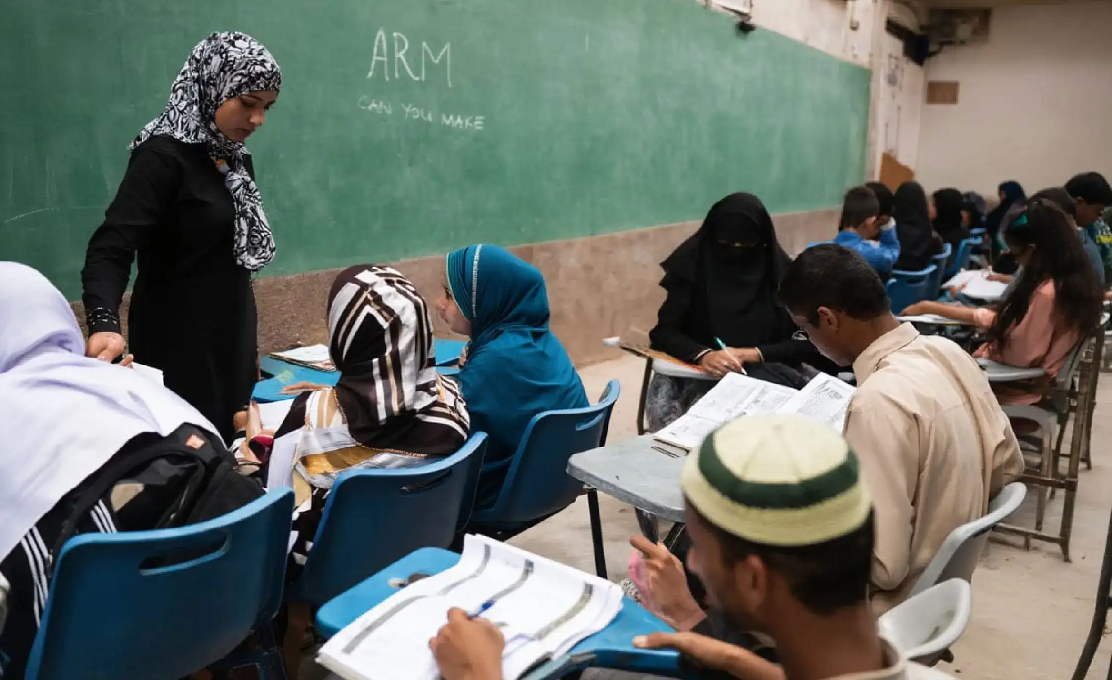 Adult students and teacher engaged in classroom learning as part of vocational and literacy support programs by Skill Development Foundation in Pakistan